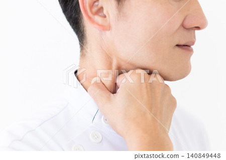 A middle-aged male acupuncturist/osteopath in a white coat pinches the neck muscles (sternocleidomastoid muscle) to relieve headaches. A middle-aged male acupuncturist/osteopath in a white coat pinches the neck muscles (sternocleidomastoid muscle) to relieve headaches. 140849448