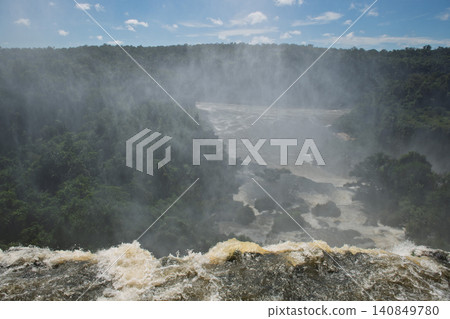 Powerful water plunges down majestic iguazu falls creating magnificent heavy mist Powerful water plunges down majestic iguazu falls creating magnificent heavy mist 140849780