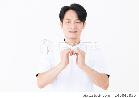 A middle-aged male acupuncturist/osteopath wearing a white coat. A middle-aged male acupuncturist/osteopath wearing a white coat. 140849839