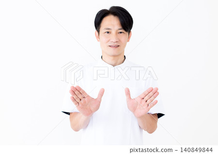 A middle-aged male acupuncturist/osteopath wearing a white coat. A middle-aged male acupuncturist/osteopath wearing a white coat. 140849844