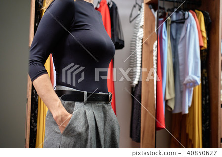 Woman checking outfit before work In wardrobe Woman checking outfit before work In wardrobe 140850627