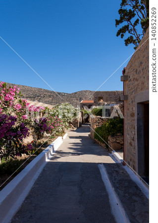 Vertical Street View with Blooming Oleander Flowers on Spinalonga Vertical Street View with Blooming Oleander Flowers on Spinalonga 140852269