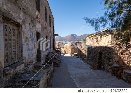 Abandoned stone street with ruined buildings on historic Spinalonga island Greece Abandoned stone street with ruined buildings on historic Spinalonga island Greece 140852291