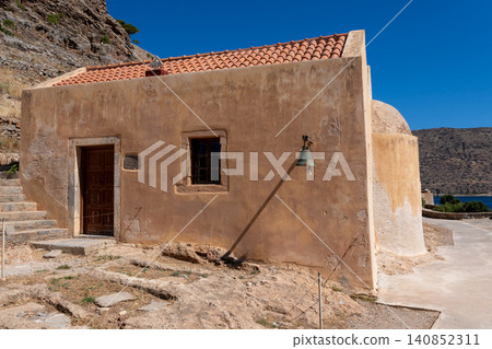 Historic stone church with orange tiled roof on Spinalonga island Greece Historic stone church with orange tiled roof on Spinalonga island Greece 140852311