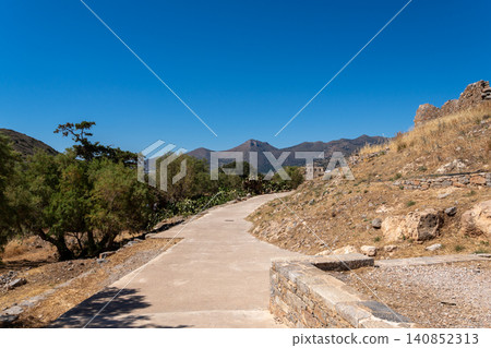 Concrete walkway leading through historic stone ruins on Spinalonga island Greece Concrete walkway leading through historic stone ruins on Spinalonga island Greece 140852313