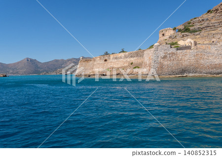 Scenic view of Venetian fortress on Spinalonga island from sea in Crete Greece Scenic view of Venetian fortress on Spinalonga island from sea in Crete Greece 140852315