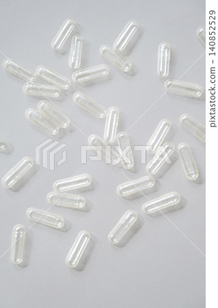 Empty clear capsule scattered on grey surface. Empty clear capsule scattered on grey surface. 140852529