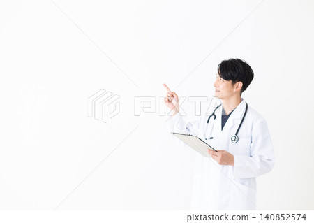 A middle-aged male doctor in a white coat holding a binder. A middle-aged male doctor in a white coat holding a binder. 140852574