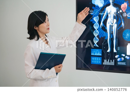 一位女醫生一邊看著螢幕一邊交談。醫療、保健、檢查、治療、諮詢、會議。 一位女醫生一邊看著螢幕一邊交談。醫療、保健、檢查、治療、諮詢、會議。 140852776