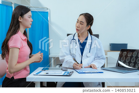 Female doctor explaining to patient results of model brain. Diagnosis of diseases. Female doctor explaining to patient results of model brain. Diagnosis of diseases. 140853021