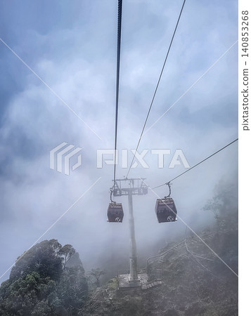 Genting Highlands cable car gondola with Coach branding in fog above mountain resort in Pahang Malaysia Genting Highlands cable car gondola with Coach branding in fog above mountain resort in Pahang Malaysia 140853268