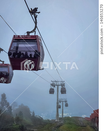 Genting Highlands cable car gondola with Coach branding in fog above mountain resort in Pahang Malaysia 140853270
