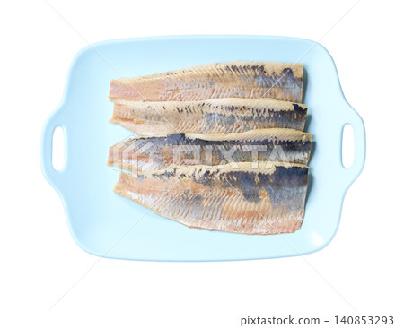 A blue plate with atlantic herring fillet isolated on a white background, top view. A blue plate with atlantic herring fillet isolated on a white background, top view. 140853293
