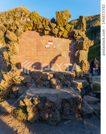 Summit marker stone plaque of Mount Batur volcano at 1717 meters, Bali, Indonesia Summit marker stone plaque of Mount Batur volcano at 1717 meters, Bali, Indonesia 140853392