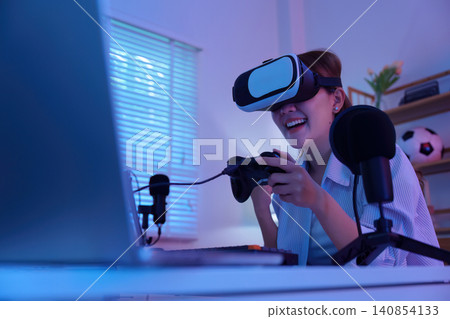 Asian woman wearing VR headset holding controller for virtual reality gaming Asian woman wearing VR headset holding controller for virtual reality gaming 140854133