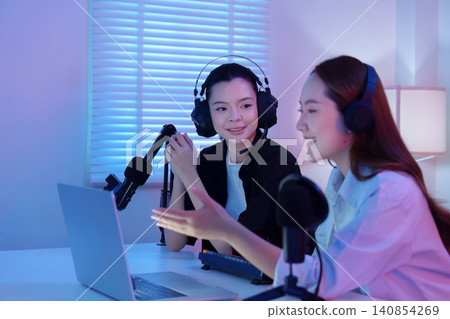 Two Asian women co hosting podcast and live streaming in home studio Two Asian women co hosting podcast and live streaming in home studio 140854269