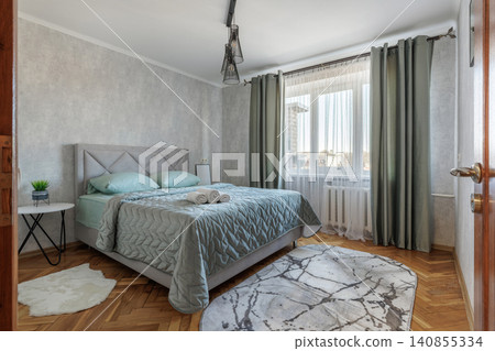 Modern Apartment Bedroom Interior with Made Double Bed and Window Modern Apartment Bedroom Interior with Made Double Bed and Window 140855334