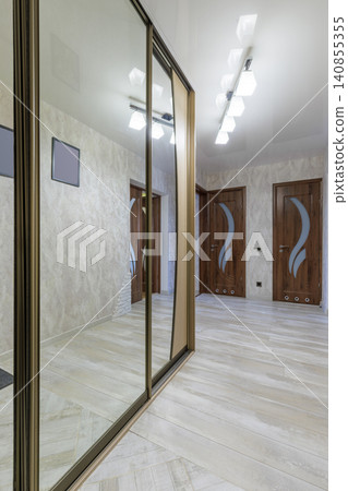 Apartment Hallway Design with Large Mirror Wardrobe and Wooden Doors Apartment Hallway Design with Large Mirror Wardrobe and Wooden Doors 140855355