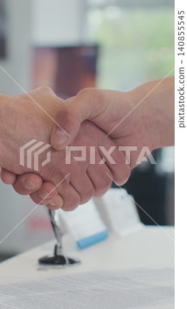 Vertical Video Young man selling car, handshake at car dealership with bought cars in background. Vertical Video Young man selling car, handshake at car dealership with bought cars in background. 140855545