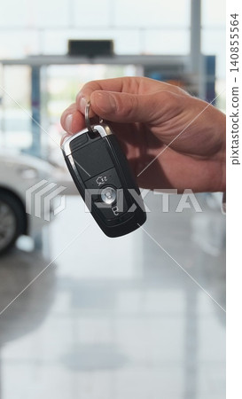 Vertical Video Car dealer giving keys to a customer against cars parked. Vertical Video Car dealer giving keys to a customer against cars parked. 140855564