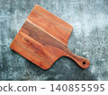 Wooden Cutting Board on Textured Surface 140855595