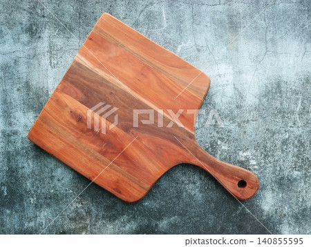Wooden Cutting Board on Textured Surface Wooden Cutting Board on Textured Surface 140855595