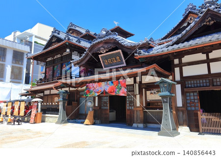 [Ehime Prefecture] Dogo Onsen Main Building under a clear blue sky after renovations 140856443