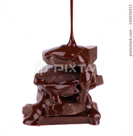 Liquid chocolate syrup pouring over a stack of chocolate pieces isolated on a white background. Clipping path. Liquid chocolate syrup pouring over a stack of chocolate pieces isolated on a white background. Clipping path. 140856913