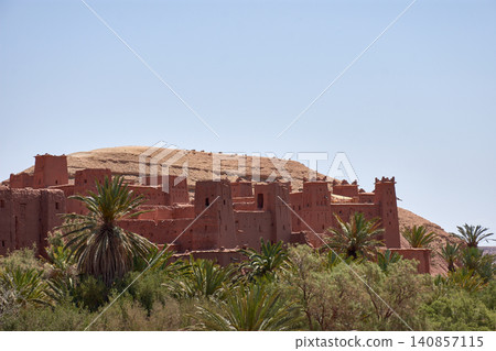 The ancient Ksar of Ait Benhaddou stands majestically beside the Mellah River in southern Morocco. The ancient Ksar of Ait Benhaddou stands majestically beside the Mellah River in southern Morocco. 140857115