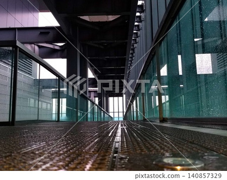The sidewalk of the Sky Promenade, wet from the rain. The sidewalk of the Sky Promenade, wet from the rain. 140857329