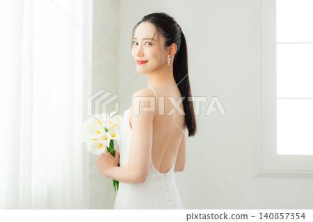 young woman in a white dress 140857354