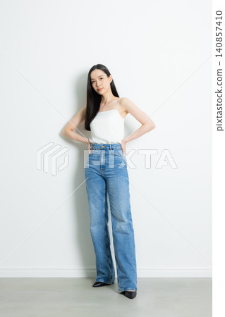 A female model wearing jeans A female model wearing jeans 140857410