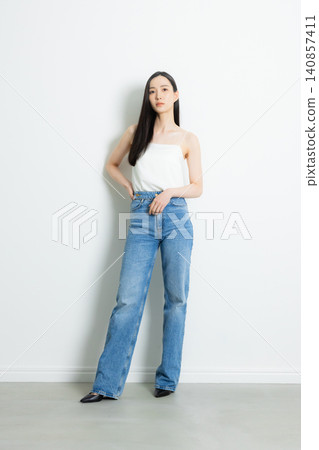 A female model wearing jeans A female model wearing jeans 140857411
