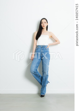 A female model wearing jeans 140857415