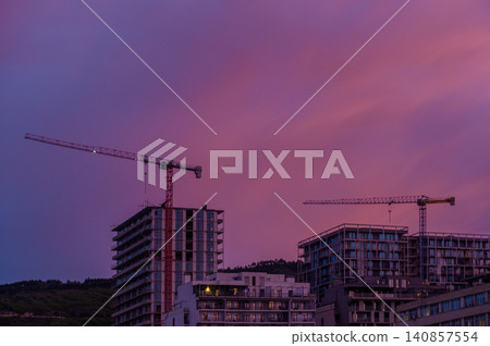Construction Site with Tower Cranes at Sunset Construction Site with Tower Cranes at Sunset 140857554