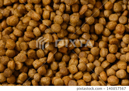 Crunchy brown morsels scattered across a surface create a textured tapestry 140857567