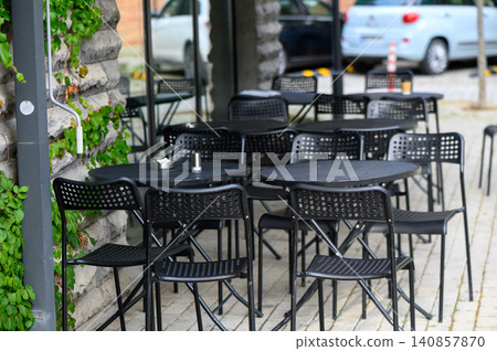 Black outdoor chairs and tables perfect for summer cafe terrace design Black outdoor chairs and tables perfect for summer cafe terrace design 140857870