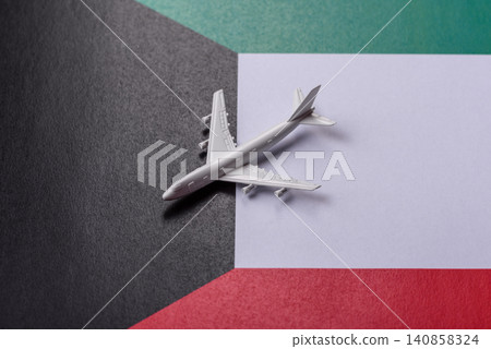 An airplane on the Kuwaiti flag as a conceptual backdrop for travel. An airplane on the Kuwaiti flag An airplane on the Kuwaiti flag as a conceptual backdrop for travel. An airplane on the Kuwaiti flag 140858324