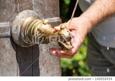 Close-up of a Hand Spout of Fountain to Drink Fresh Water in Europe street 140858434