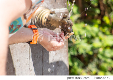 Close-up of a Hand Spout of Fountain to Drink Fresh Water in Europe street Close-up of a Hand Spout of Fountain to Drink Fresh Water in Europe street 140858439