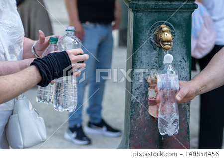 People Filling Plastic Bottles with Fresh Water from a Traditional Public Fountain in Milan Italy Europe People Filling Plastic Bottles with Fresh Water from a Traditional Public Fountain in Milan Italy Europe 140858456