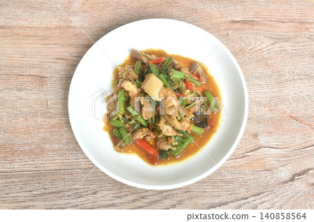 spicy stir fried fat pork belly couple slice yard long bean with basil on plate spicy stir fried fat pork belly couple slice yard long bean with basil on plate 140858564