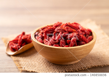 Organic dried goji berries in a wooden bowl. Healthy food Organic dried goji berries in a wooden bowl. Healthy food 140858836