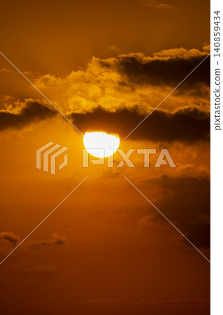 Beautiful golden sunset over the river with a small boat and sun reflection on the water. Beautiful golden sunset over the river with a small boat and sun reflection on the water. 140859434