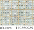 A flat front view of a geometric wall pattern featuring small light blue textured ceramic tiles arranged in a uniform grid with visible mortar lines 140860029