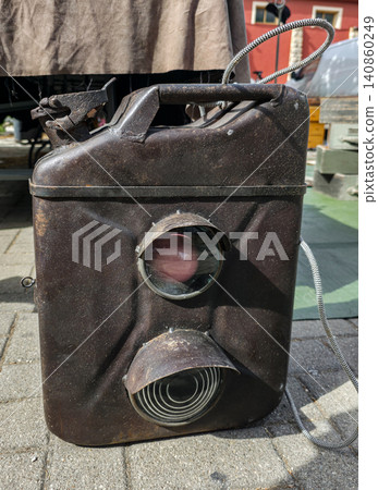 This object is a vintage German military railway signal lantern known as Einheitslaterne. It has a jerrycan shape with colored traffic light lenses and is shown in a historical context. This object is a vintage German military railway signal lantern known as Einheitslaterne. It has a jerrycan shape with colored traffic light lenses and is shown in a historical context. 140860249