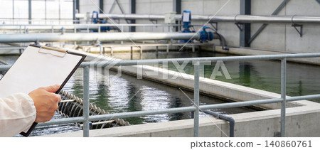 Water treatment plant inspection with clipboard and protective clothing Water treatment plant inspection with clipboard and protective clothing 140860761