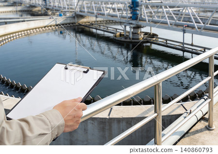 Engineer inspecting water treatment plant with clipboard and checklist Engineer inspecting water treatment plant with clipboard and checklist 140860793