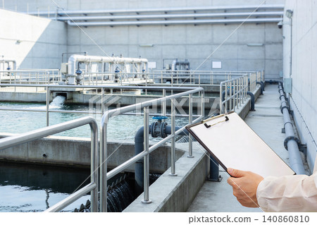 Water treatment plant inspection with clipboard and protective clothing 140860810
