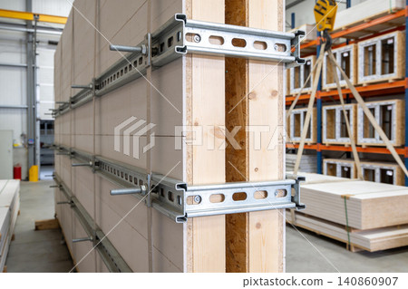 Construction materials stacked in a warehouse, ready for assembly and transport Construction materials stacked in a warehouse, ready for assembly and transport 140860907